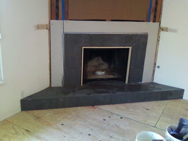 Slate fireplace surround and hearth under construction.