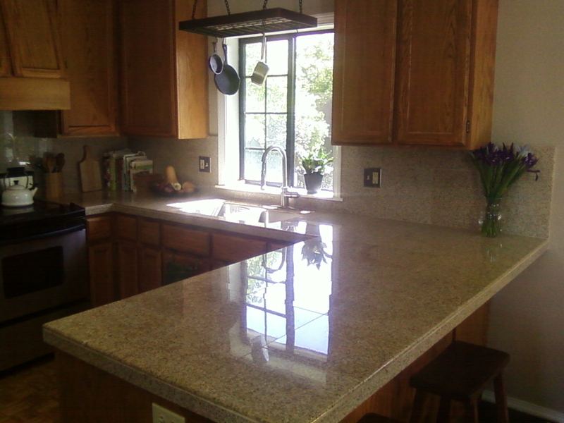 Oak kitchen with a tiled counter and breakfast bar.
